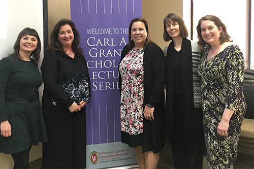Group photo of team who are standing next to a Carl A Grant banner.
